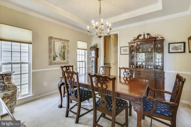 a view of a dining room with furniture and chandelier