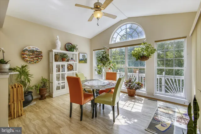 a view of a dining room with furniture wooden floor and a chandelier