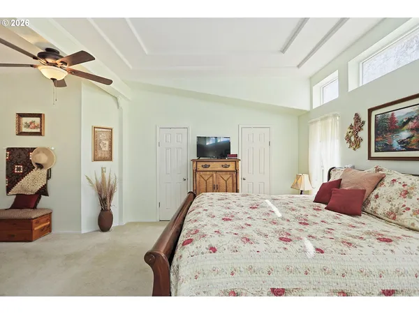 a bedroom with a bed and a television