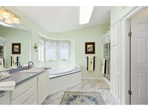a bathroom with a sink a bathtub and a mirror