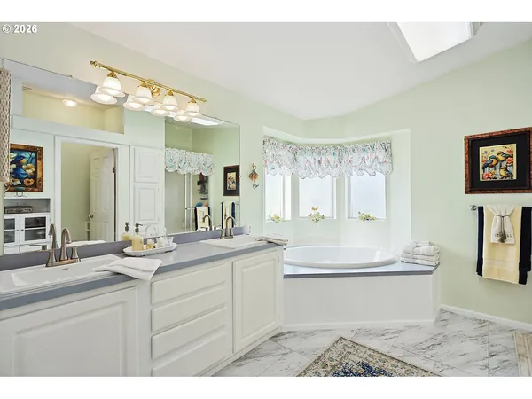 a bathroom with a sink vanity granite and a mirror
