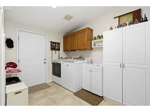 a kitchen with cabinets and white appliances