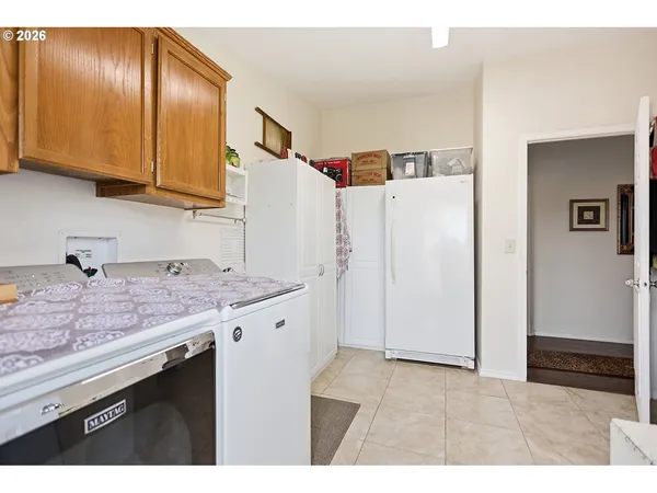 a kitchen with granite countertop cabinets and refrigerator