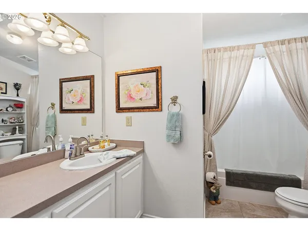a bathroom with a sink mirror and vanity