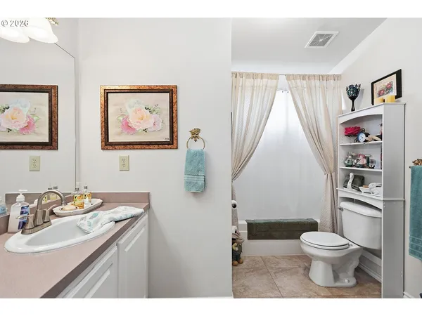 a bathroom with a toilet a sink and a mirror