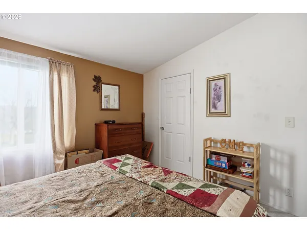 a bedroom with a bed and a dresser in it