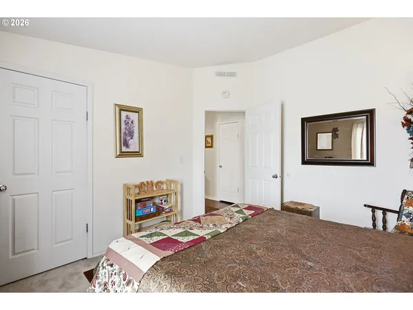 a bedroom with a bed and a table in it
