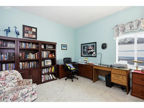 a living room with furniture window and book shelf