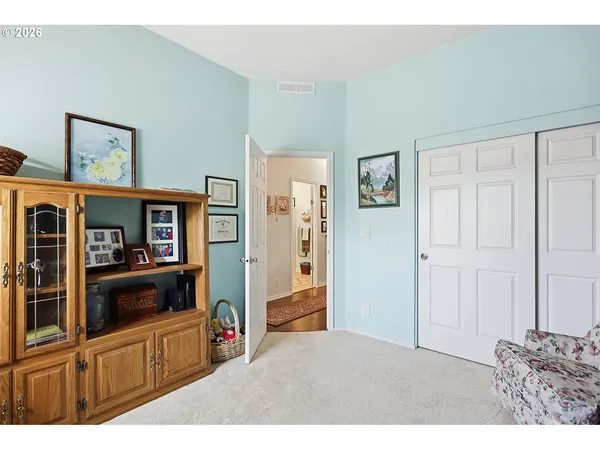 a living room with furniture and a book shelf