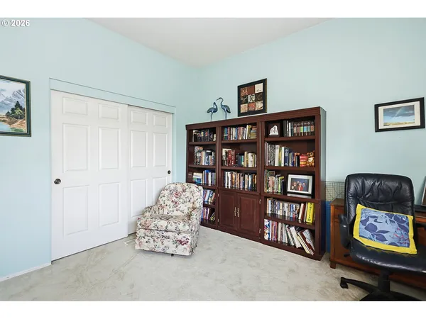 a living room with furniture flowerpot and wooden floor