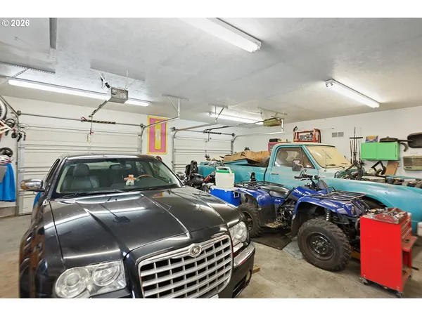 a view of a big house with a big yard and large trees
