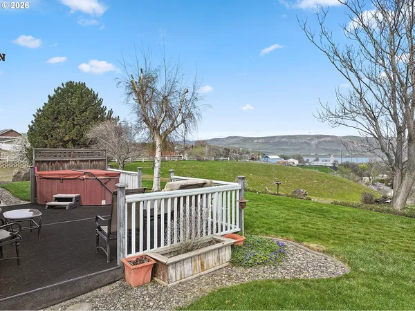 a view of a big yard with a house in the background