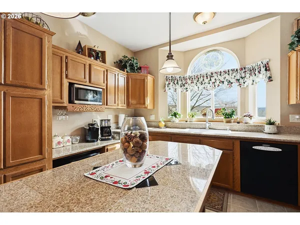 a kitchen with a refrigerator a stove a sink and a cabinets
