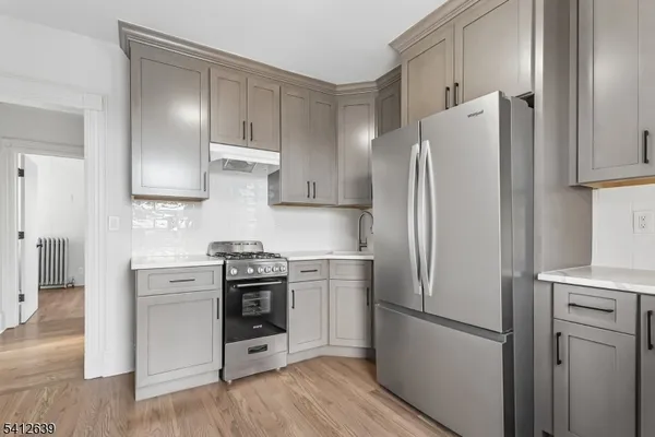 a kitchen with stainless steel appliances a refrigerator stove and sink