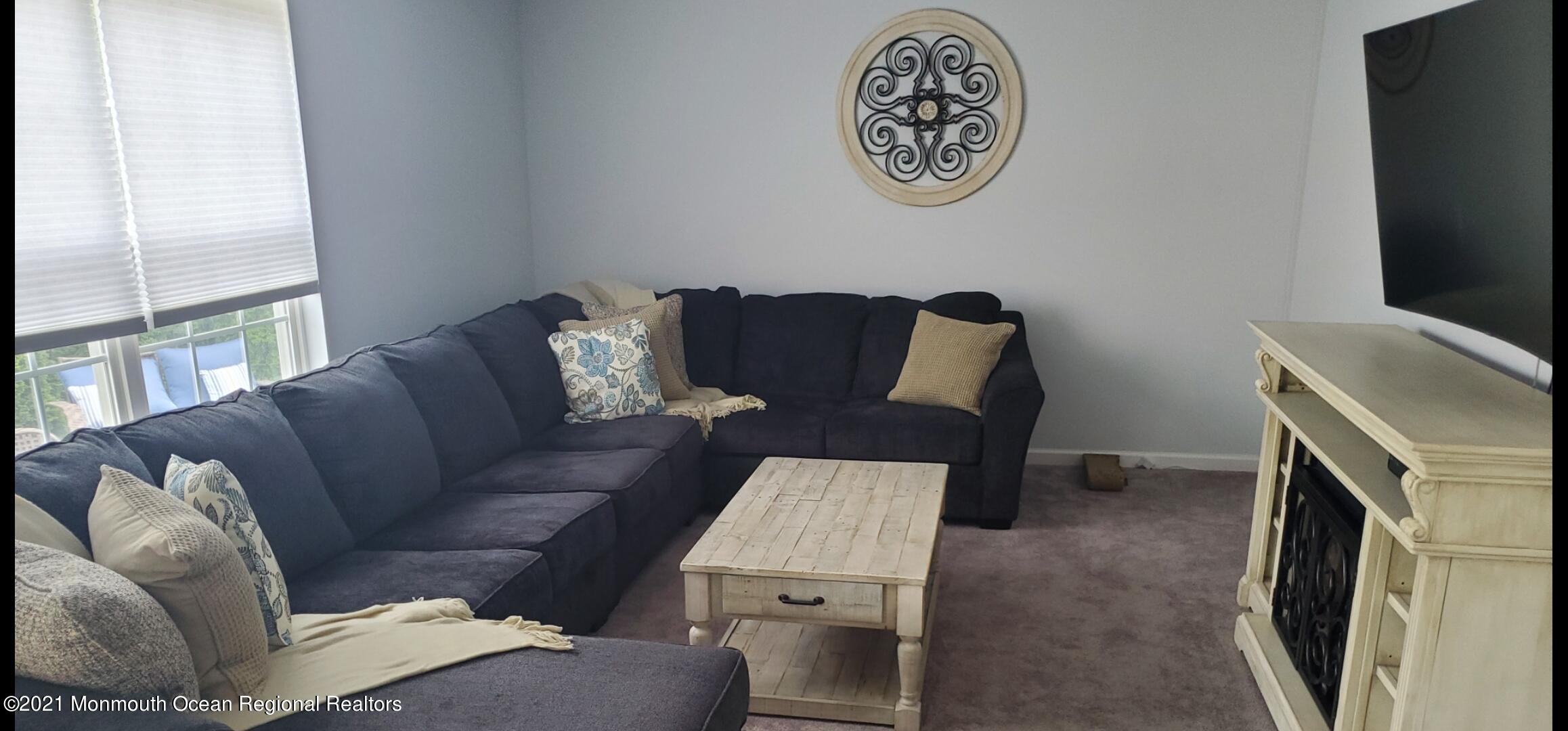 128 Captain Road Manahawkin, NJ 08050 - Photo 11 of 20 a living room with furniture and a flat screen tv