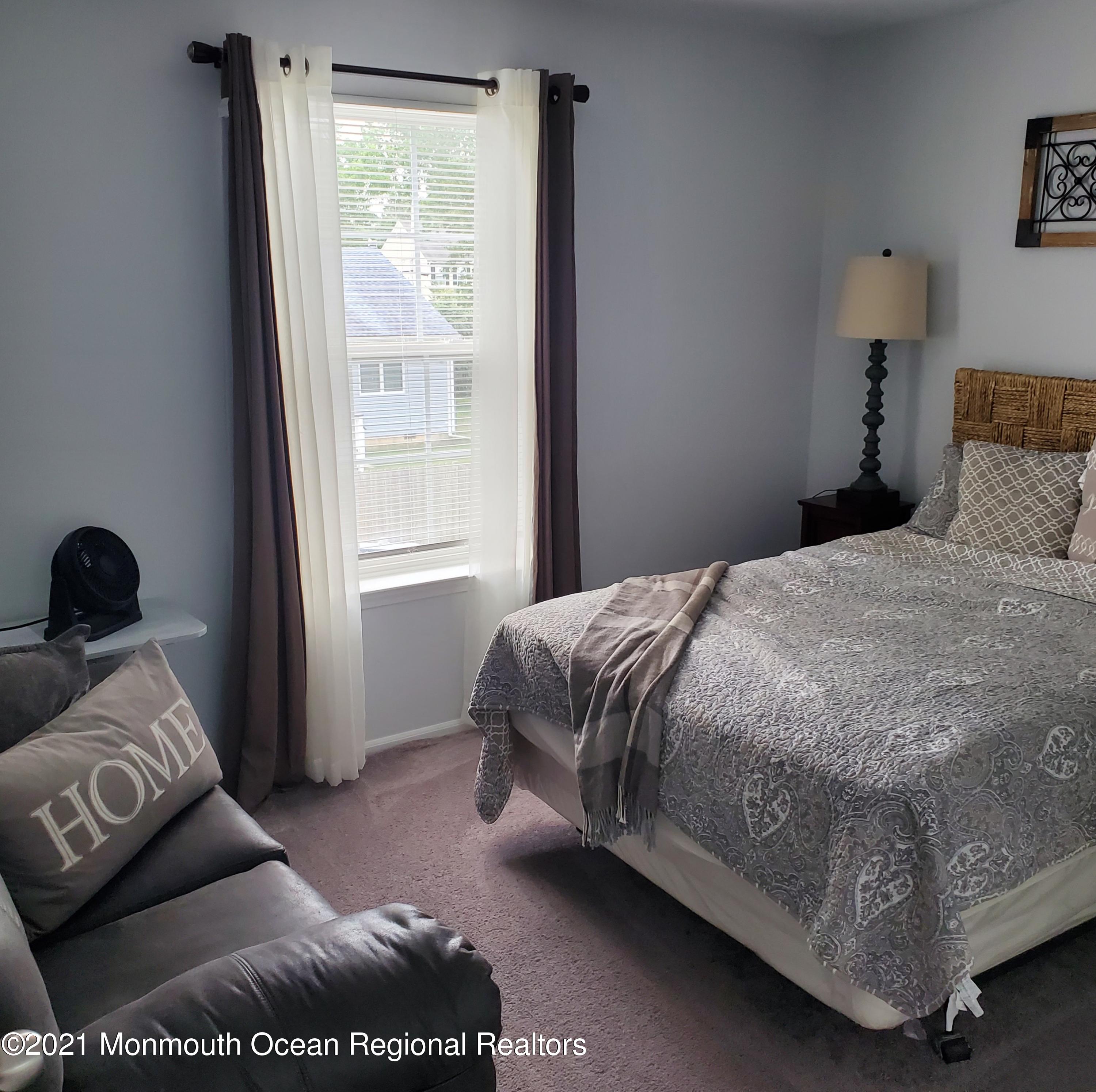 128 Captain Road Manahawkin, NJ 08050 - Photo 12 of 20 a bedroom with a bed and a window