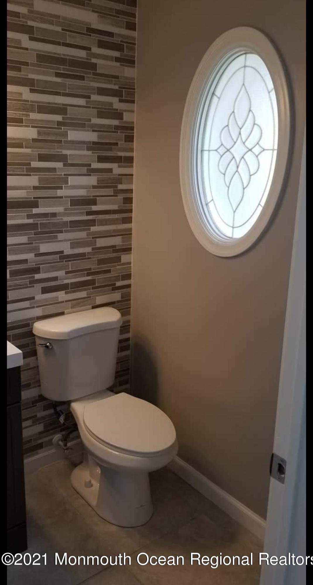 128 Captain Road Manahawkin, NJ 08050 - Photo 14 of 20 a white toilet sitting next to a shower