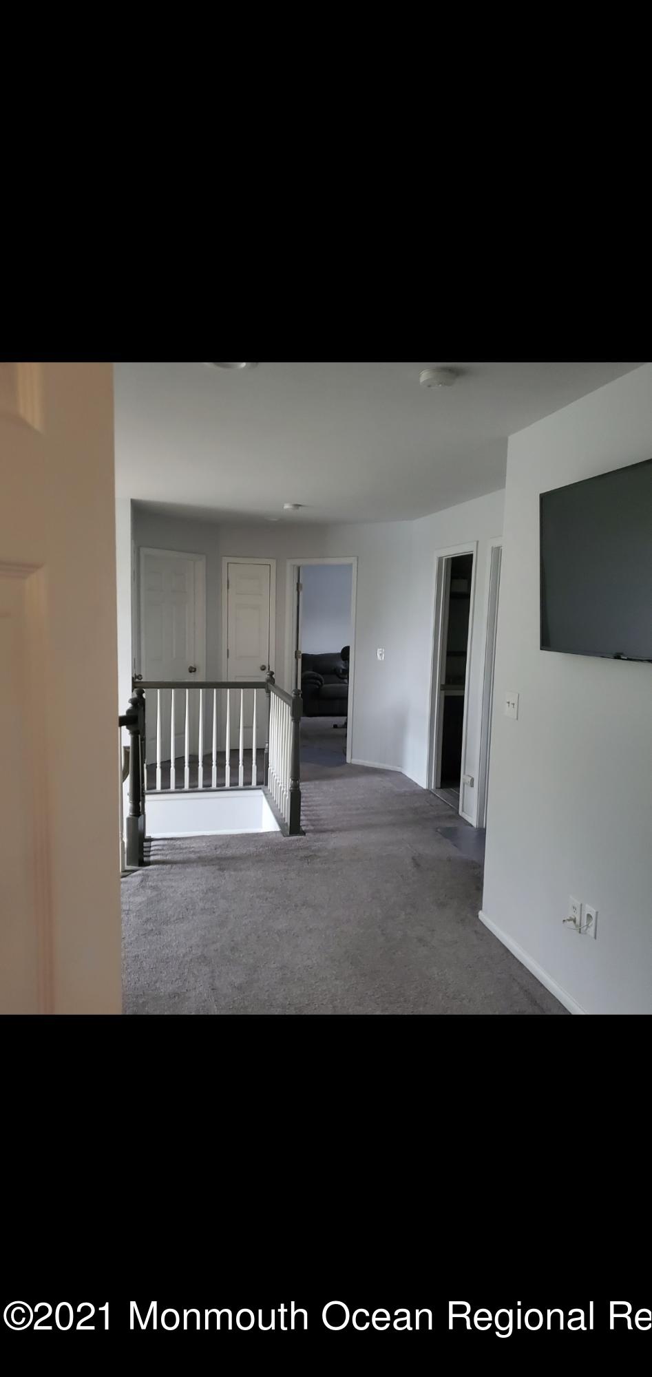 128 Captain Road Manahawkin, NJ 08050 - Photo 16 of 20 a view of an empty room with a tv