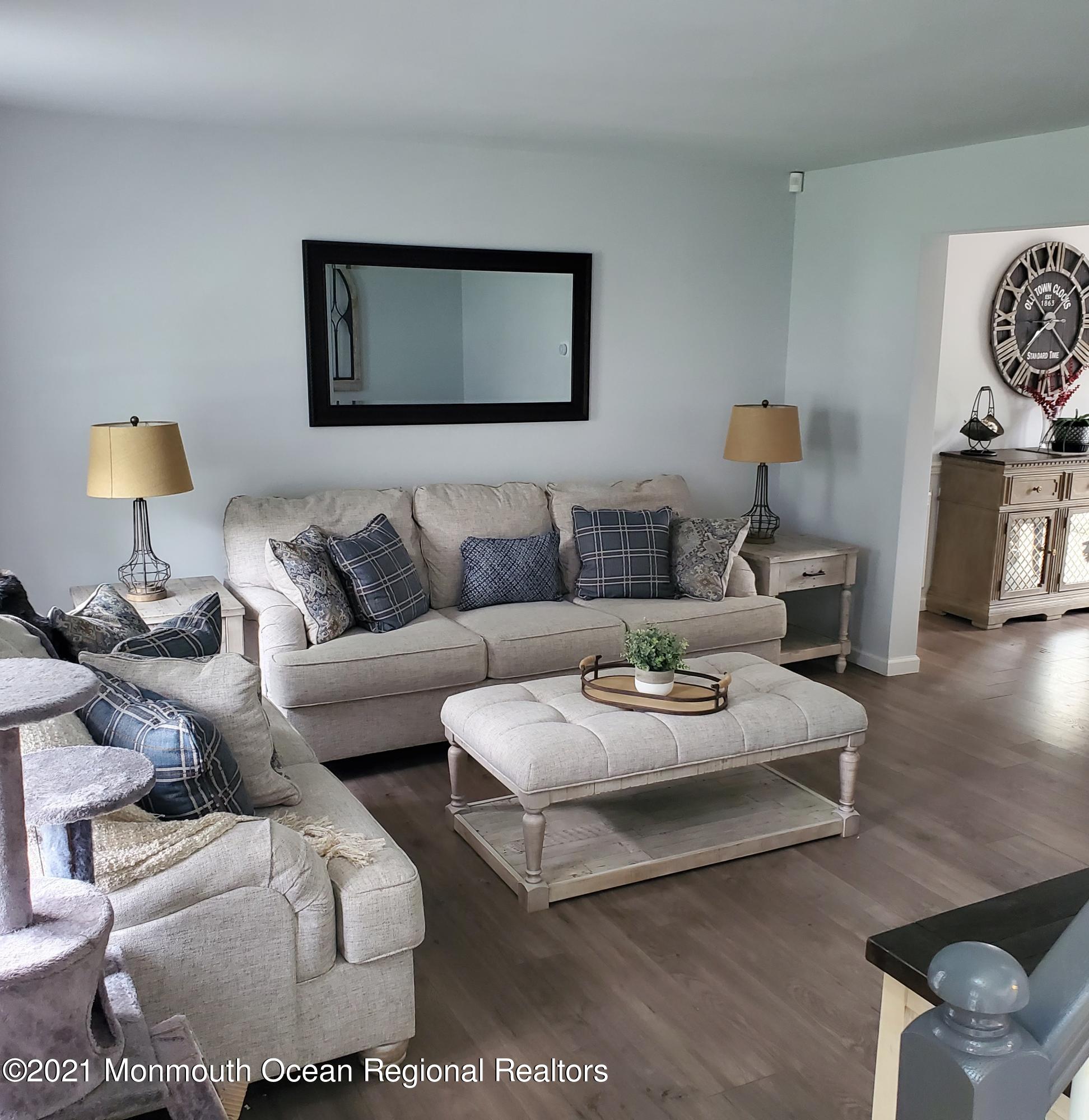 128 Captain Road Manahawkin, NJ 08050 - Photo 7 of 20 a living room with furniture and a lamp