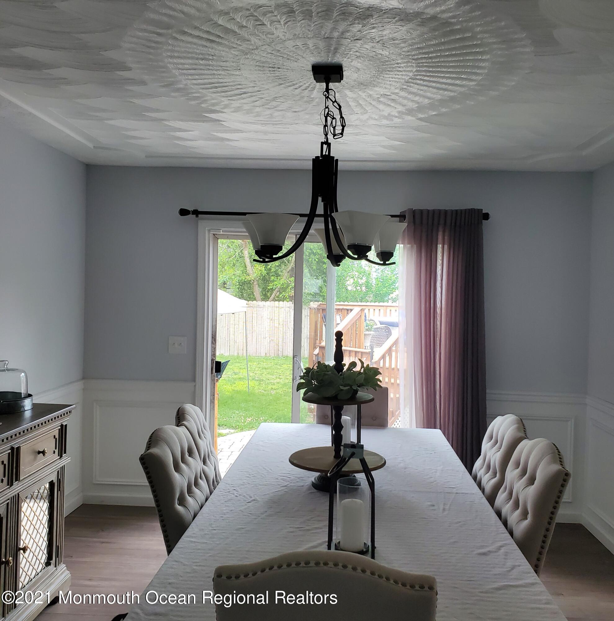128 Captain Road Manahawkin, NJ 08050 - Photo 8 of 20 a living room with furniture and a chandelier