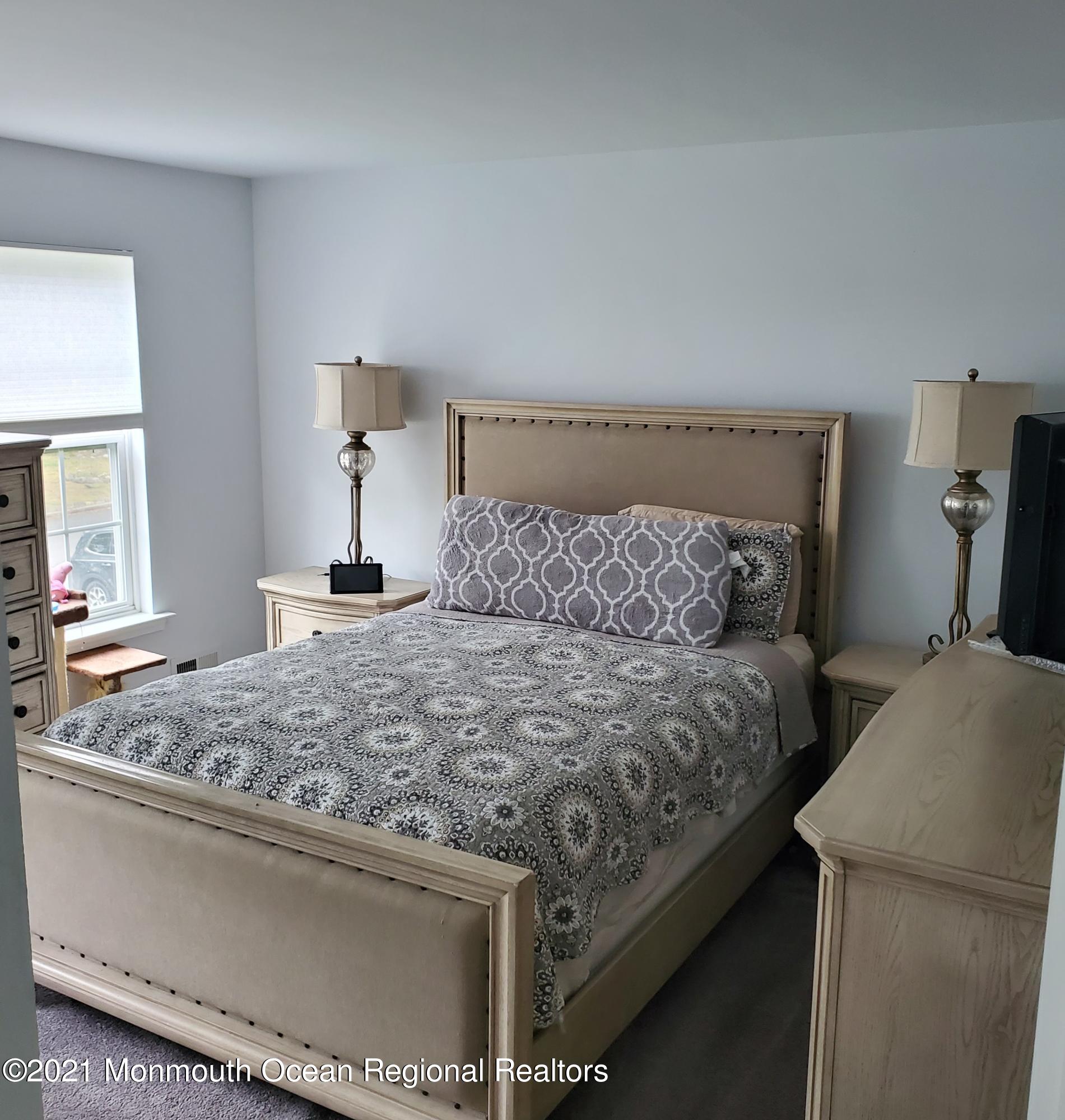 128 Captain Road Manahawkin, NJ 08050 - Photo 10 of 20 a bedroom with a bed and a dresser