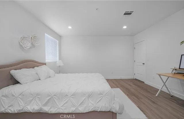 a bedroom with a bed and cabinets