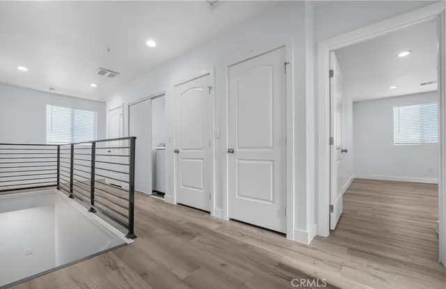 a view of a hallway with wooden floor