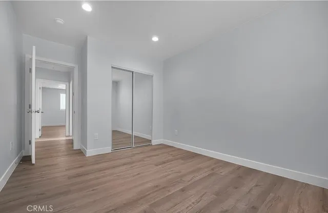 a view of an empty room and wooden floor