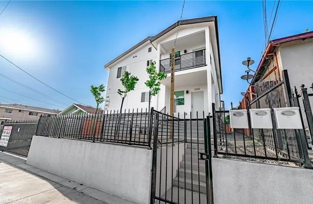 a view of staircase with railing and white walls