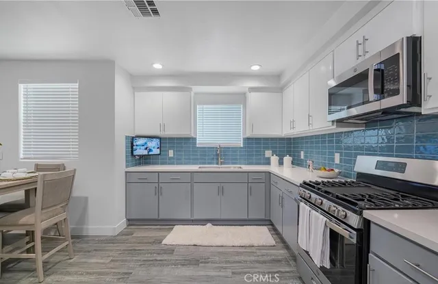 a kitchen with a sink stove and microwave