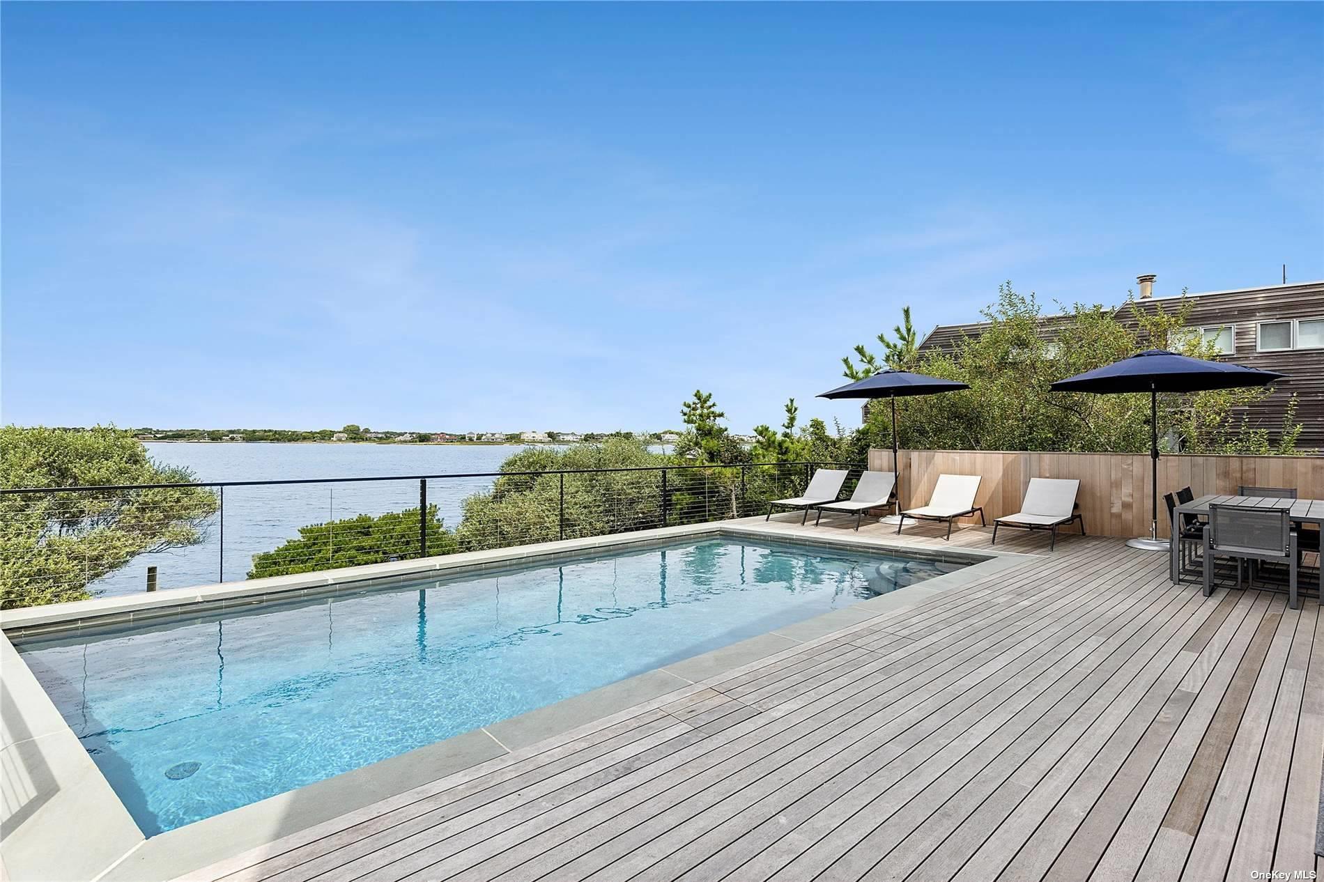 314 Dune Road Westhampton Beach, NY 11978 - Photo 18 of 18 a view of a swimming pool with a patio