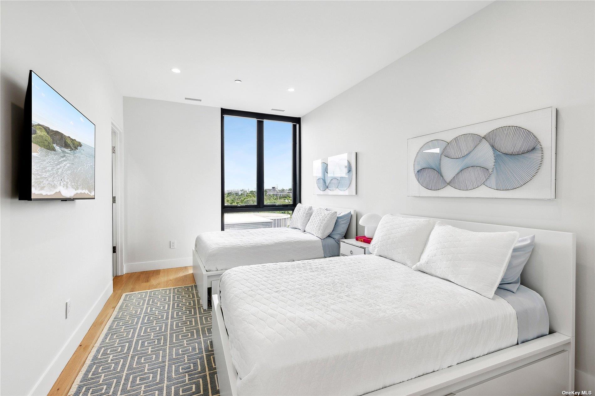 314 Dune Road Westhampton Beach, NY 11978 - Photo 7 of 18 a bedroom with a bed and a window