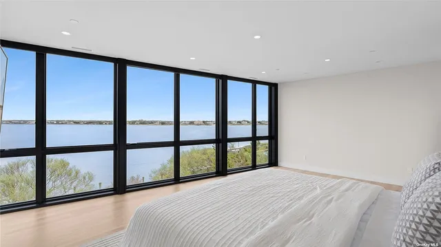 a large bedroom with a large window and a bed