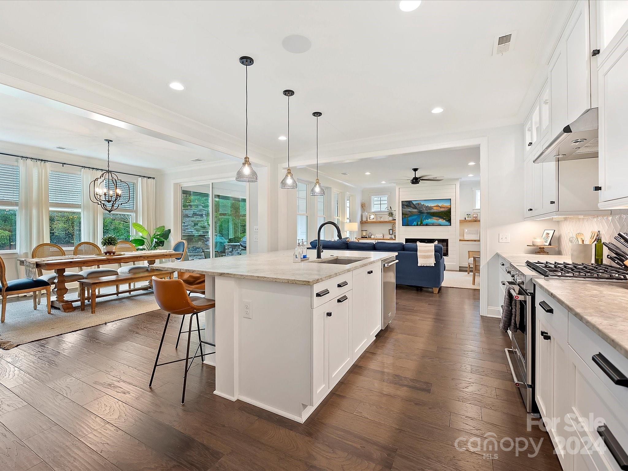 12027 Huntson Reserve Road Huntersville, NC 28078 - Photo 14 of 42 a large kitchen with lots of counter space dining table and chairs