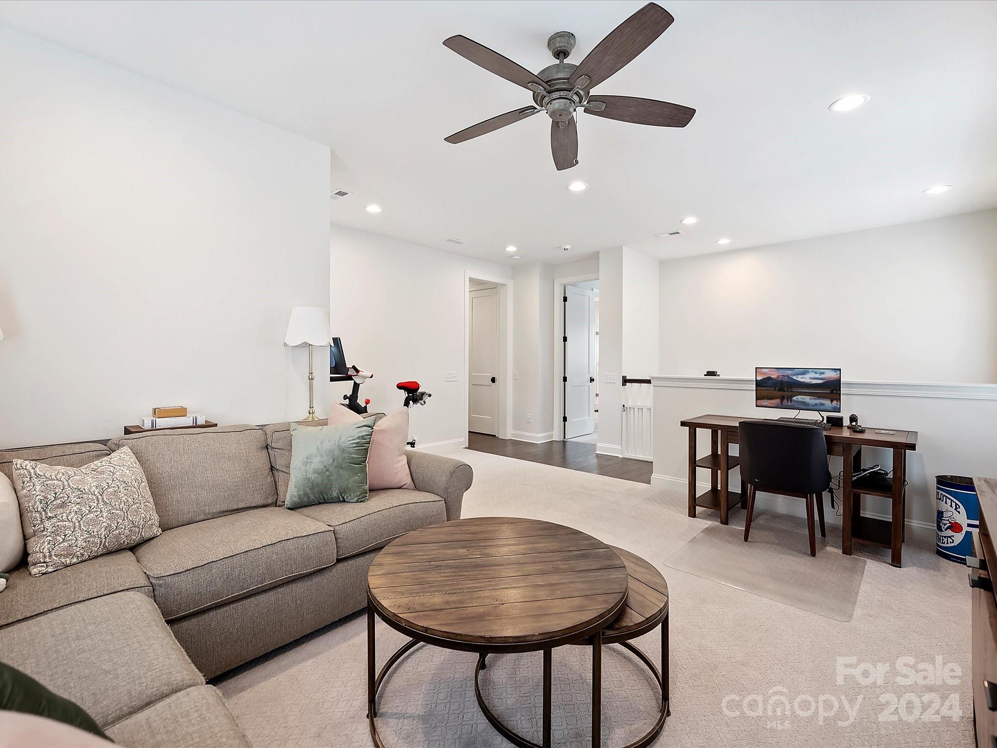 12027 Huntson Reserve Road Huntersville, NC 28078 - Photo 23 of 42 a living room with furniture and a dining table with projector screen