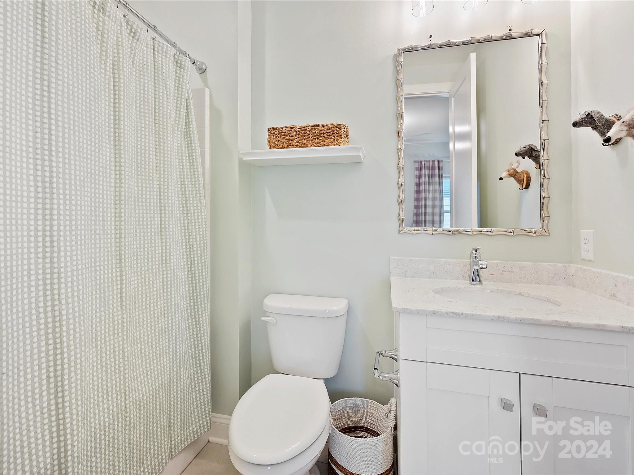 12027 Huntson Reserve Road Huntersville, NC 28078 - Photo 28 of 42 a white toilet sitting next to a bathroom sink