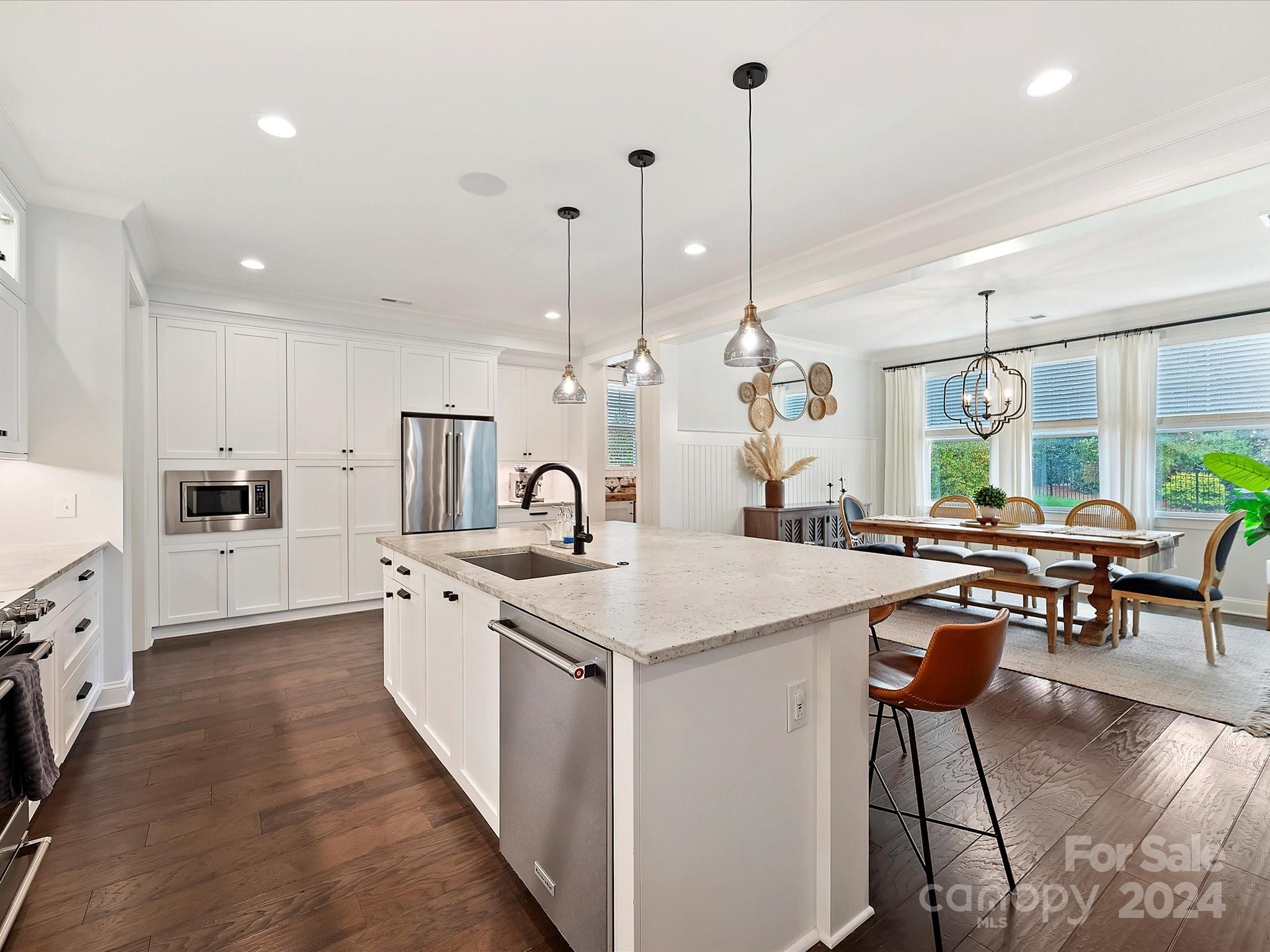 12027 Huntson Reserve Road Huntersville, NC 28078 - Photo 10 of 42 a large kitchen with kitchen island a large island in it