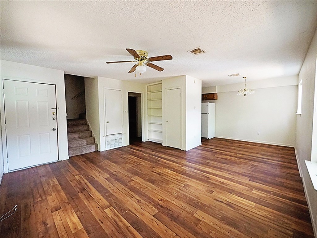 a bedroom with a bed and a ceiling fan