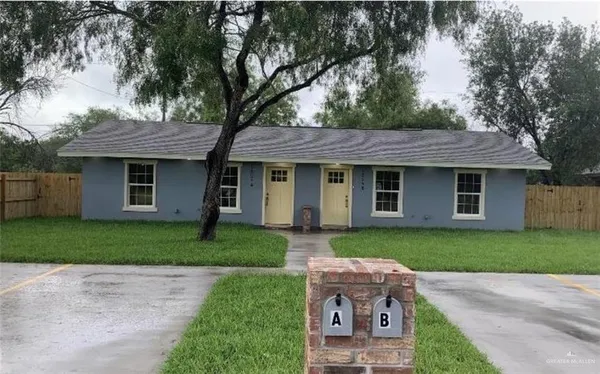 a front view of a house with a garden and yard