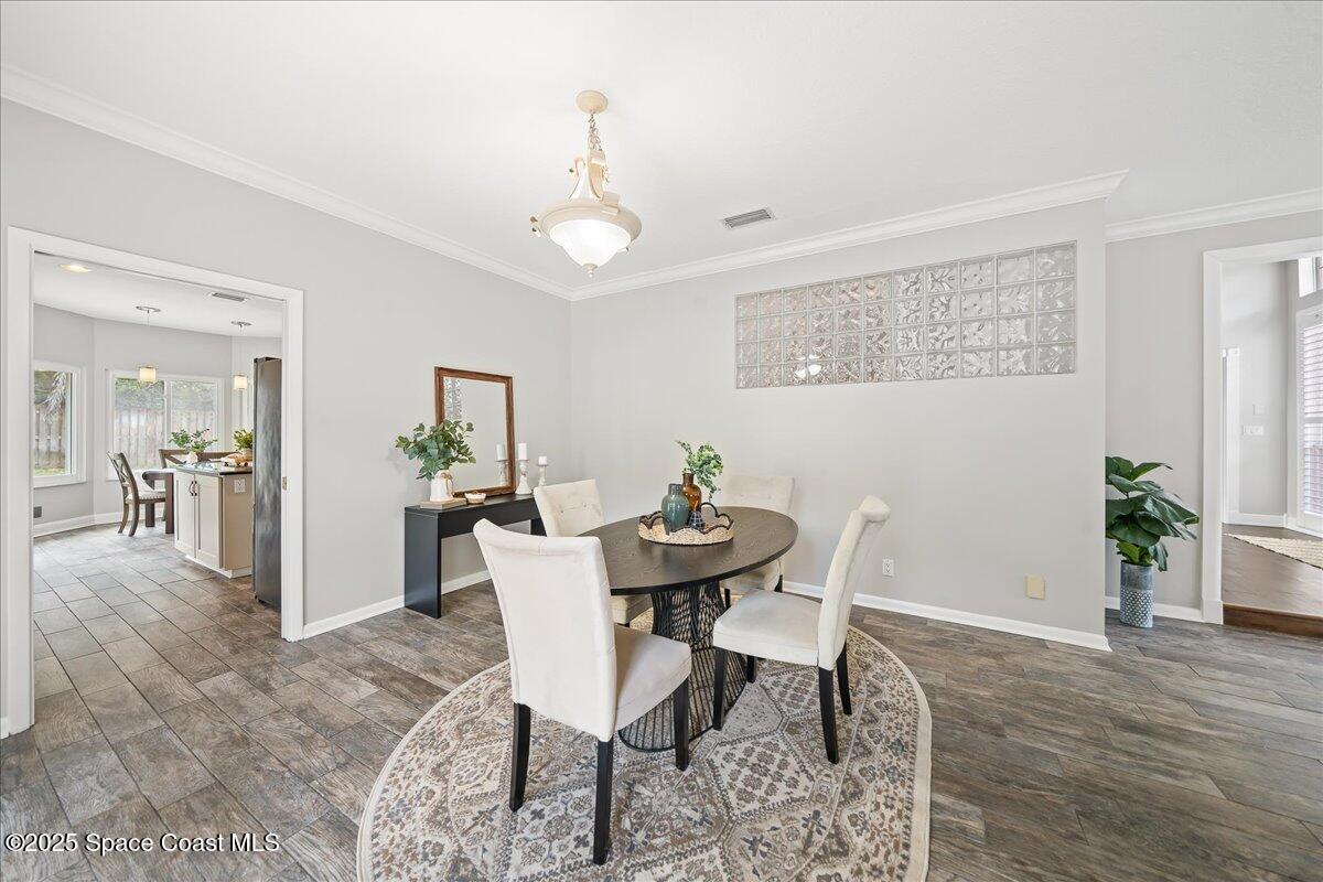 505 Sanderling Drive Indialantic, FL 32903 - Photo 13 of 63 a view of a dining room with furniture and wooden floor