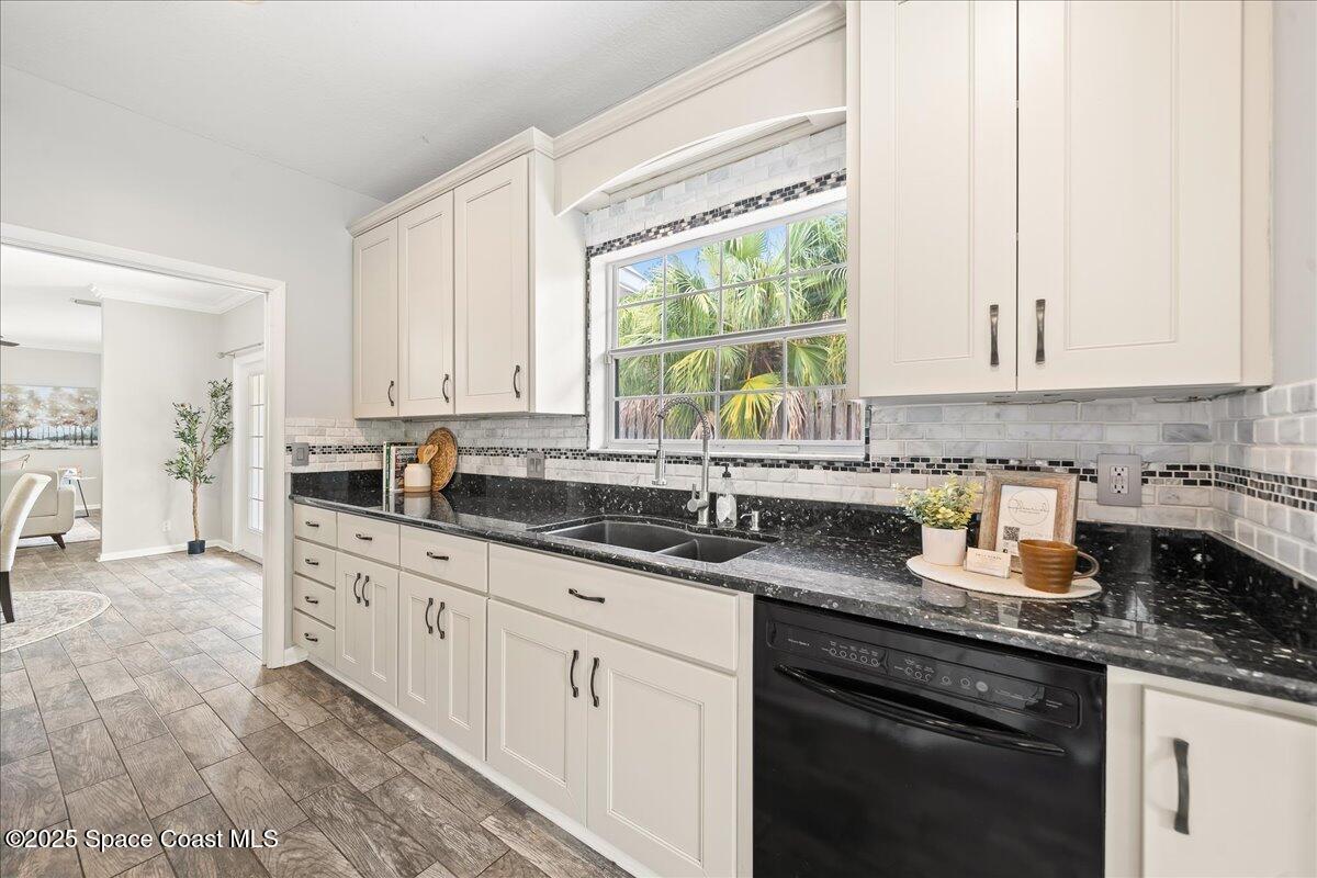 505 Sanderling Drive Indialantic, FL 32903 - Photo 14 of 63 a kitchen with granite countertop white cabinets and white appliances