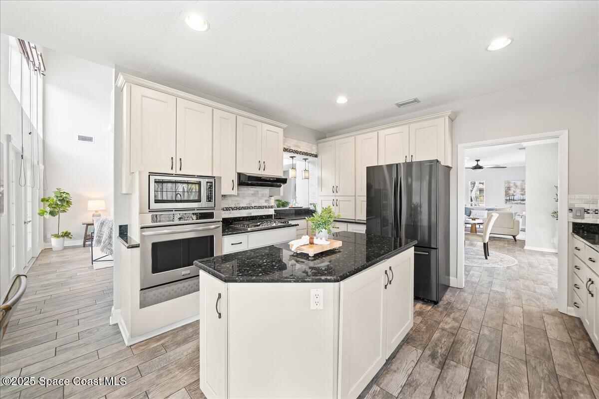 505 Sanderling Drive Indialantic, FL 32903 - Photo 15 of 63 a kitchen with a refrigerator a stove top oven a sink and dishwasher