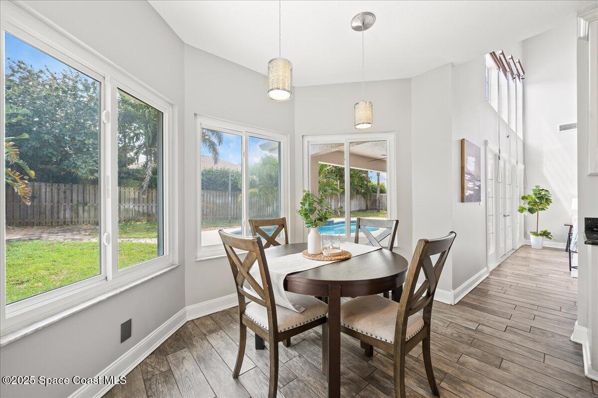 505 Sanderling Drive Indialantic, FL 32903 - Photo 18 of 63 a view of a dining room with furniture window and wooden floor