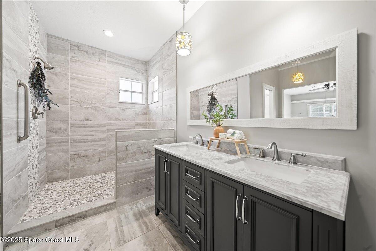 505 Sanderling Drive Indialantic, FL 32903 - Photo 21 of 63 a bathroom with a granite countertop double vanity sink and mirror