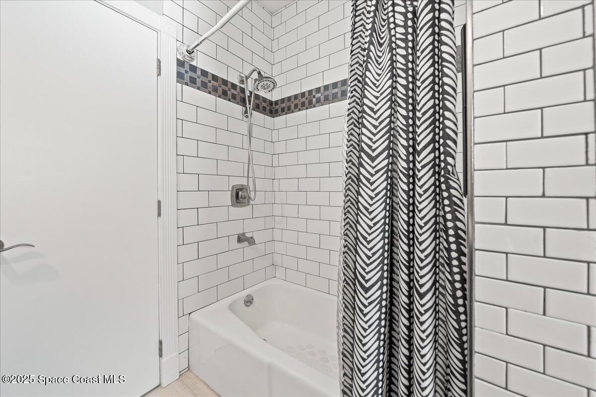 505 Sanderling Drive Indialantic, FL 32903 - Photo 27 of 63 a bathroom with a bathtub and shower