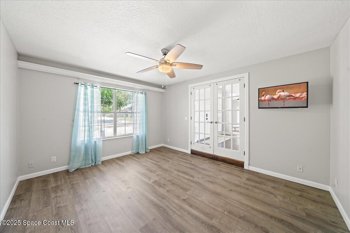 505 Sanderling Drive Indialantic, FL 32903 - Photo 29 of 63 a view of an empty room with a window and wooden floor