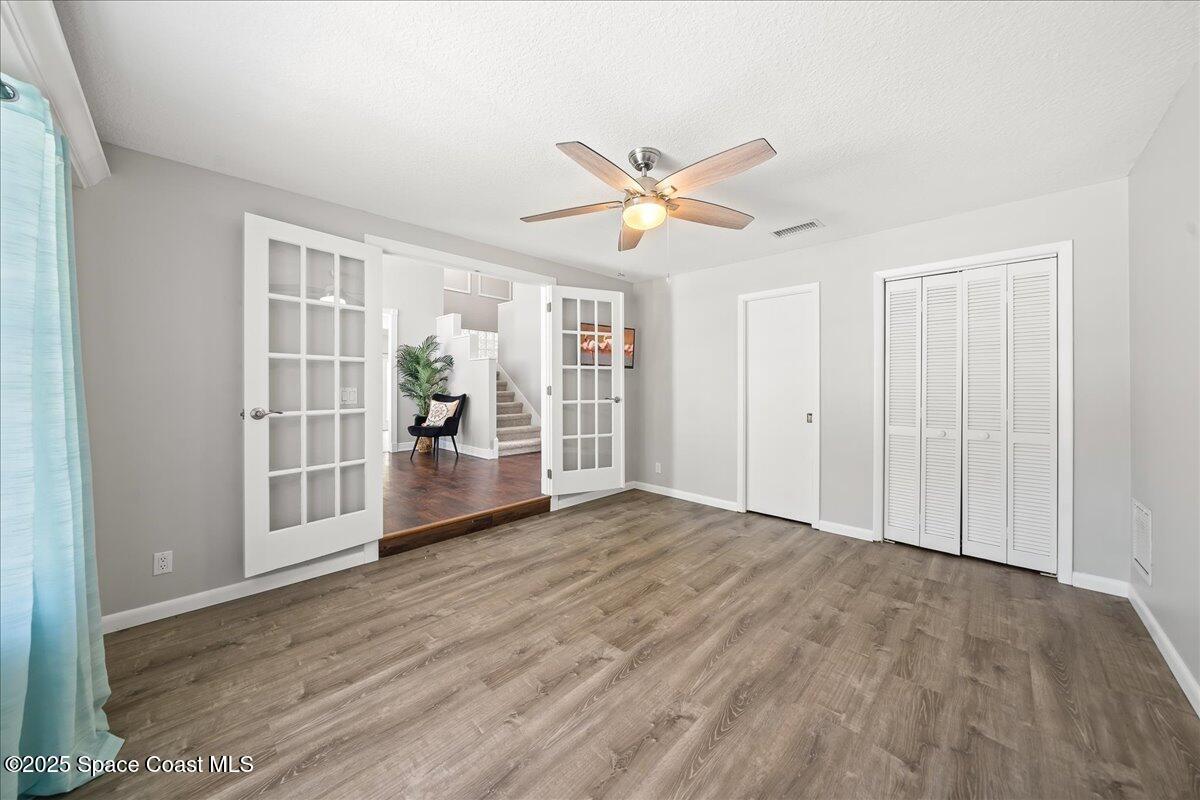 505 Sanderling Drive Indialantic, FL 32903 - Photo 30 of 63 a view of an empty room with window and wooden floor