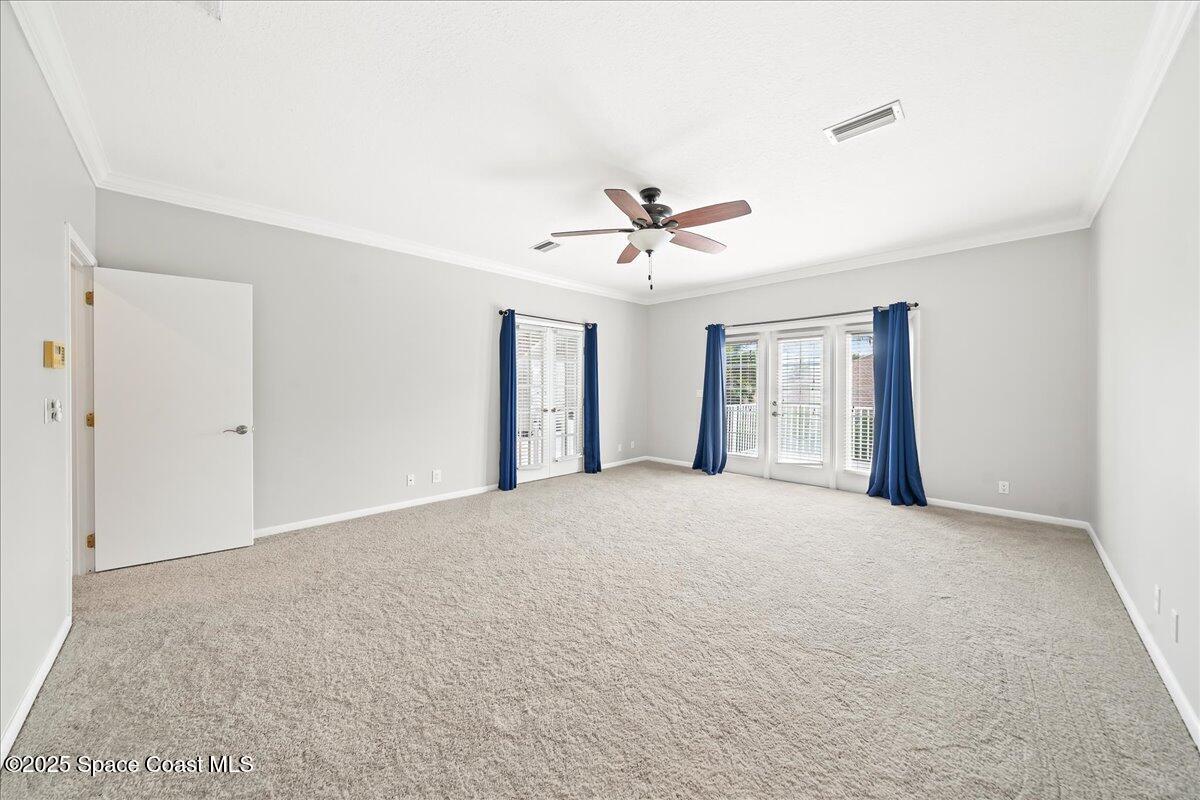 505 Sanderling Drive Indialantic, FL 32903 - Photo 37 of 63 a view of an empty room with a ceiling fan