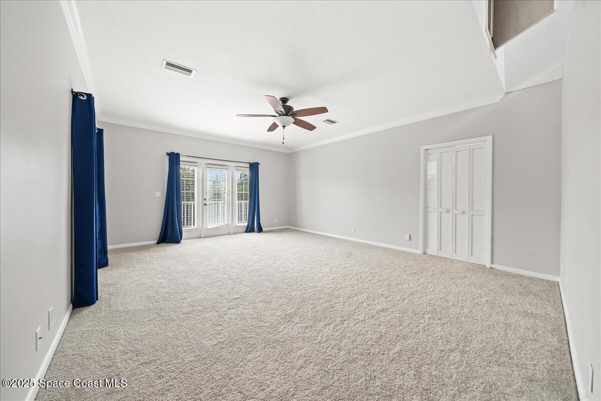 505 Sanderling Drive Indialantic, FL 32903 - Photo 38 of 63 a view of an empty room with a ceiling fan