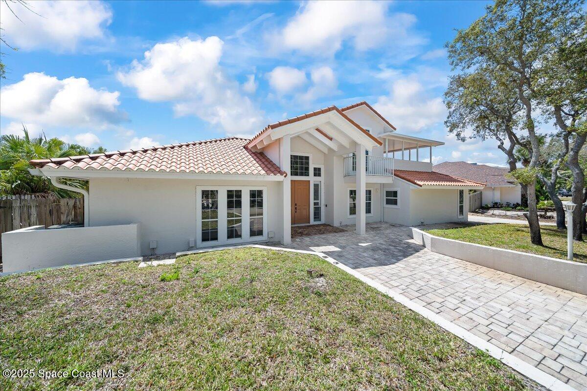 505 Sanderling Drive Indialantic, FL 32903 - Photo 52 of 63 a front view of a house with a yard and potted plants